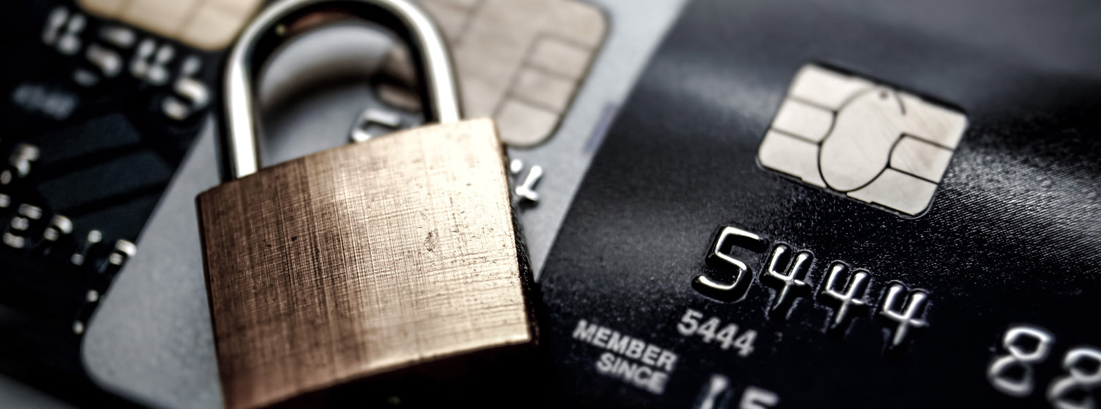 row of credit cards with padlock lying on top